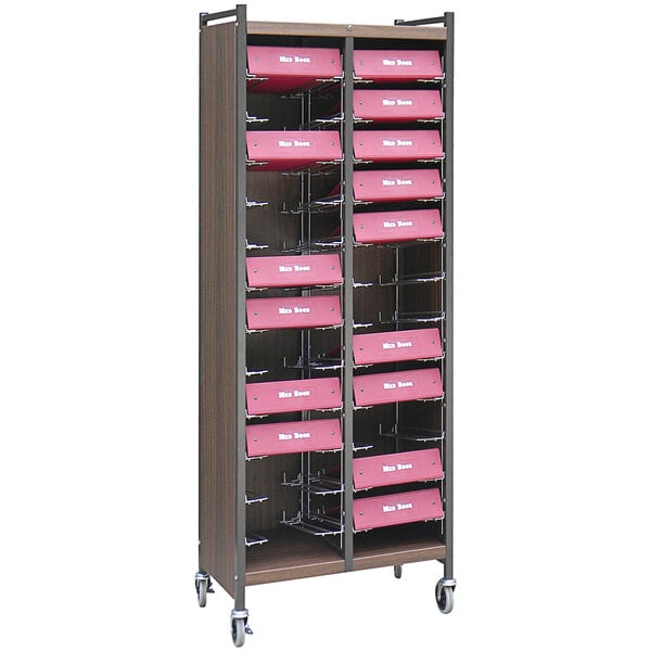 An Omnimed woodgrain medical cart with shelves of pink drawers.