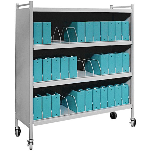 An Omnimed light gray vertical cart with blue binders on the shelves.