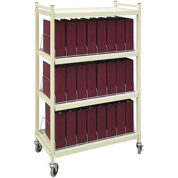 A beige metal Omnicart with four binder shelves holding several binders.