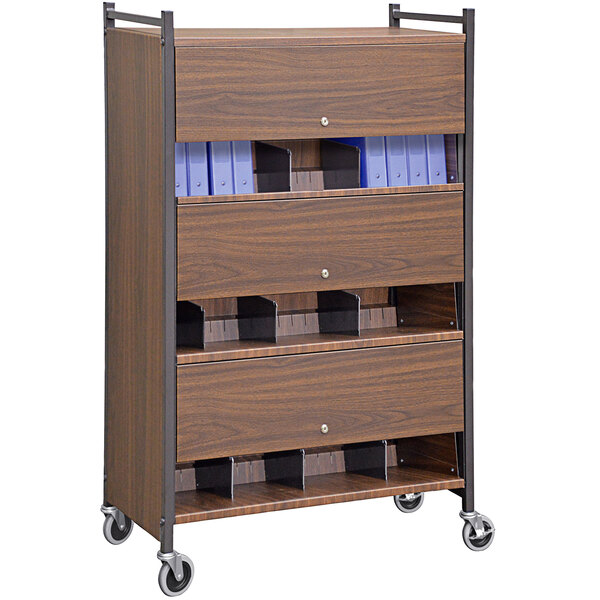 An Omnimed woodgrain cabinet rack with locking panels on wheels.