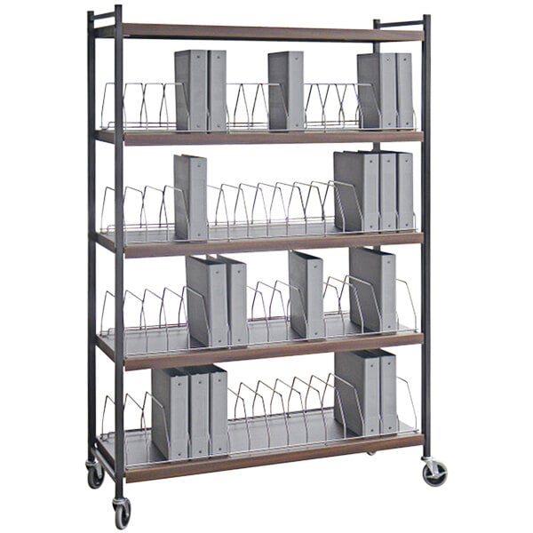 An Omnimed woodgrain metal cart shelf with binders on it.