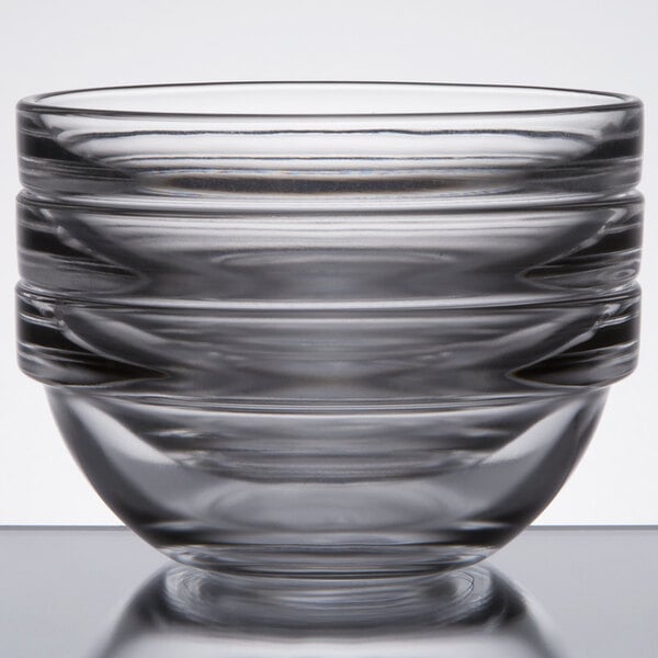 A close up of a stack of Arcoroc glass ingredient bowls. The top bowl is removed.
