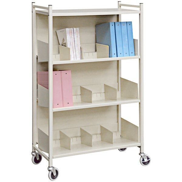 A white Omnimed open style cabinet rack with shelves and books on it.