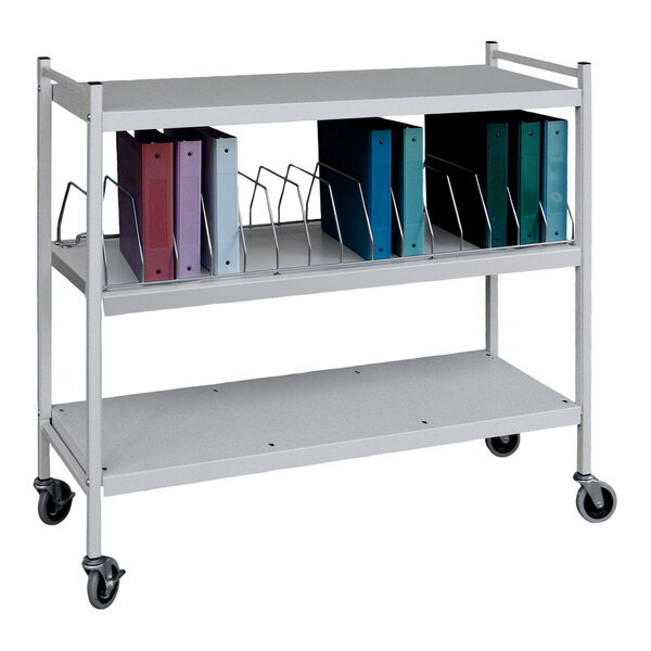 A light gray Omnimed metal cart with binders on it.