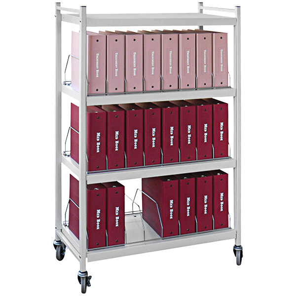 A light gray Omnimed medical cart with red binders on it.