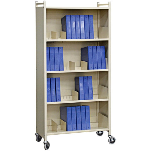 A beige Omnimed cabinet rack with blue folders and binders on the shelves.