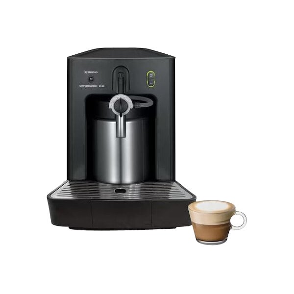 A black and silver Nespresso Cappuccinatore CS20 milk frother on a white background with a glass of brown liquid next to it.
