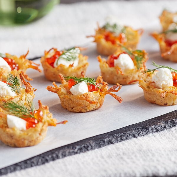 Shredded Idahoan Tater Tumblers on a plate with food.