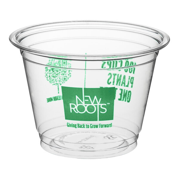 A clear plastic New Roots cold cup with green text.