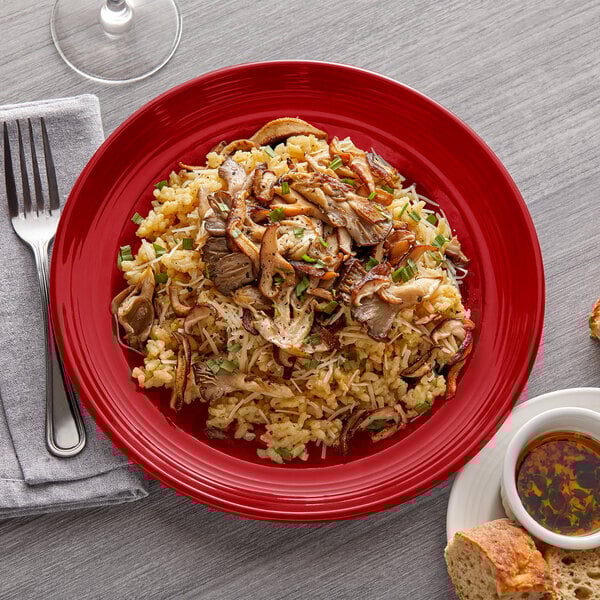 A Tuxton Concentrix cayenne china plate with food on it.