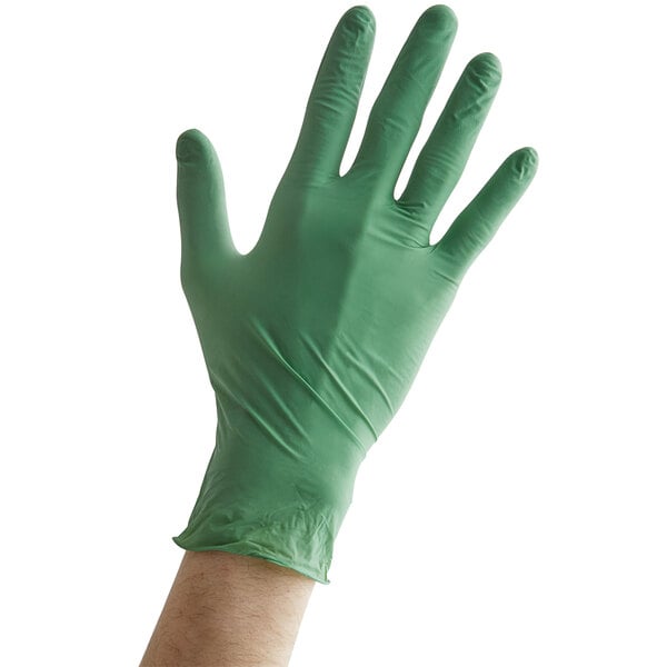 A hand wearing a green Showa biodegradable nitrile glove.