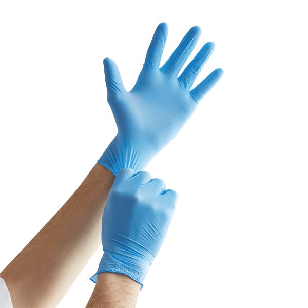 A person wearing Showa blue biodegradable nitrile gloves.