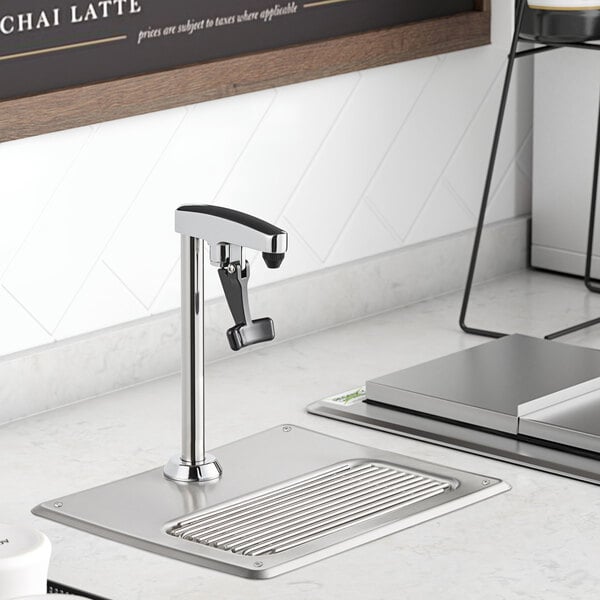 A Regency glass filler station with an 8" glass filler on a stainless steel table.
