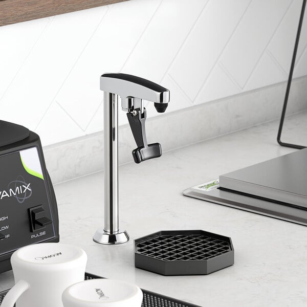 A Regency countertop glass filler on a counter next to a coffee maker.