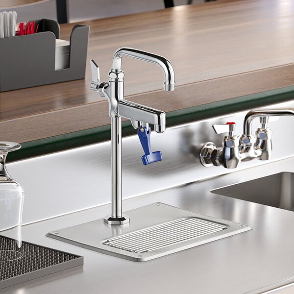 A grey drip pan under a Regency glass filler faucet on a counter.