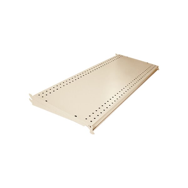 A beige metal pegboard shelf with holes in it.