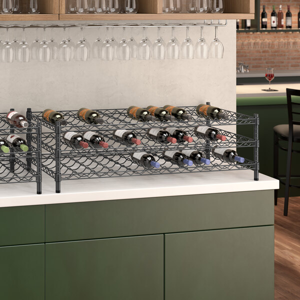 A Regency black wire wine rack holding wine bottles.