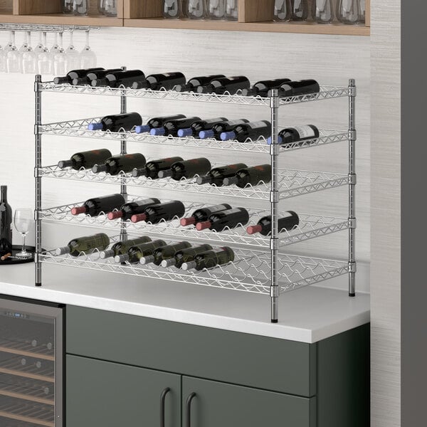 A Regency chrome wire wine rack with bottles on it.
