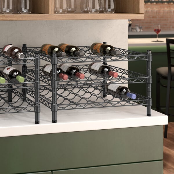 A black Regency wire wine shelf holding bottles of wine on a counter.