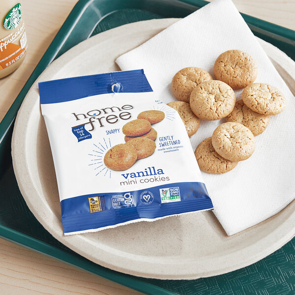A plate of Homefree Gluten-Free Mini Vanilla Cookies with a bag of cookies on the side.