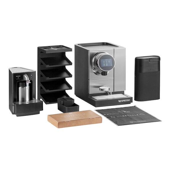 A black Nespresso coffee maker on a counter with other equipment.