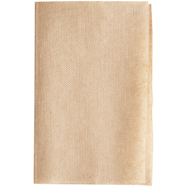 A beige Tork dispenser napkin with a brown paper background.