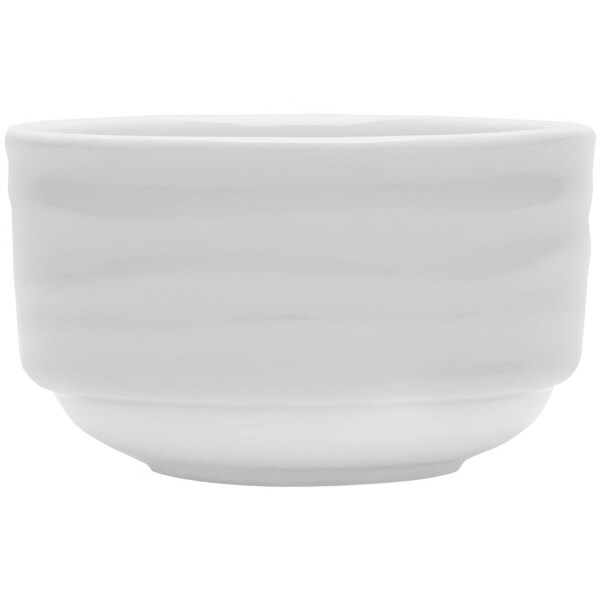 A Tuxton bright white china bouillon cup with wavy lines on the surface.