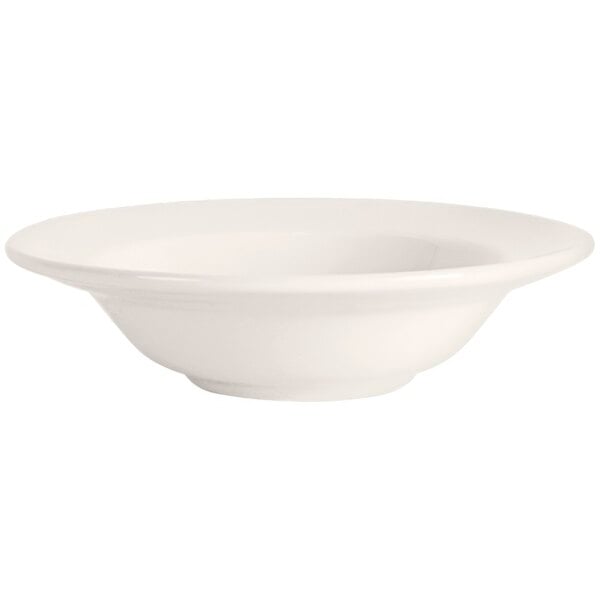 A white Tuxton Columbia fruit bowl with a rim.