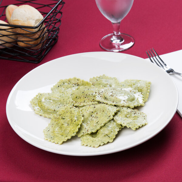 A Tuxton Venice ivory china plate with ravioli on it.