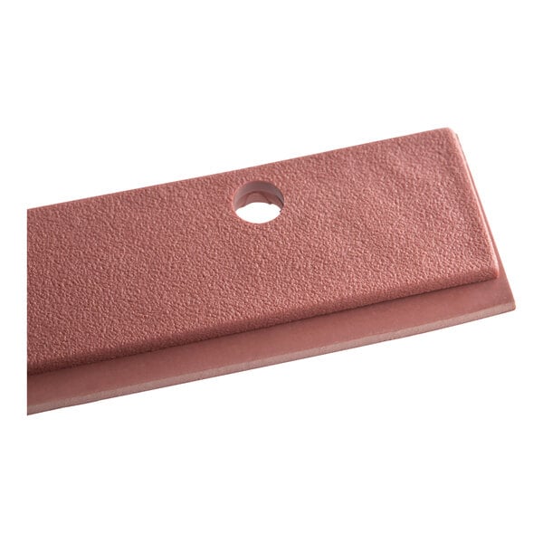 A close-up of a pink Lavex rubber blade with a hole in it.