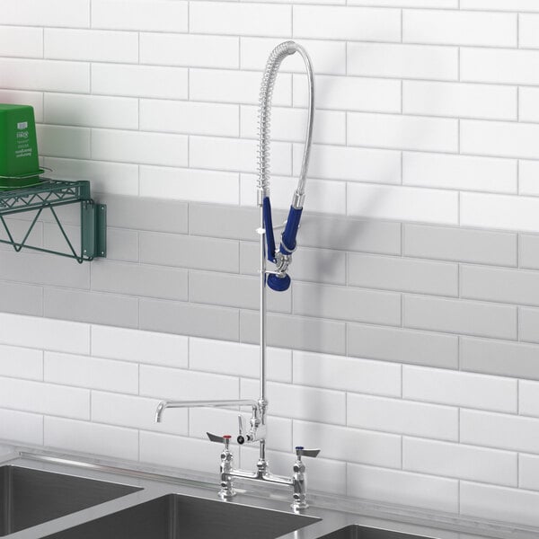 A Waterloo deck-mounted pre-rinse faucet and add-on faucet installed on a kitchen sink.