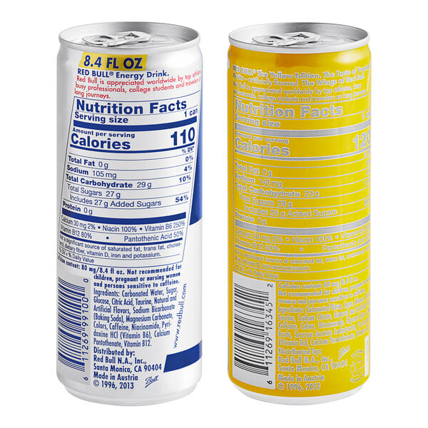A close up of a yellow Red Bull can with white and black text.