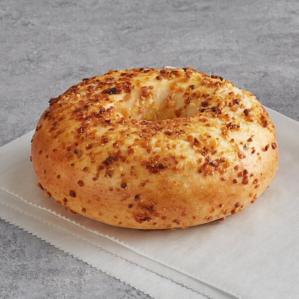 An Original Bagel with cheese and pepper on top.