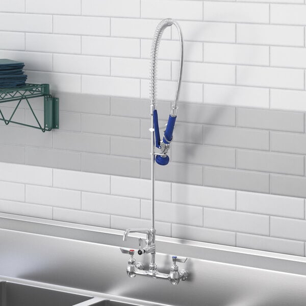 A Waterloo wall-mounted pre-rinse faucet with add-on faucet and hose.