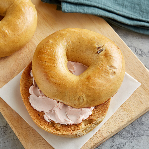 A close up of an Original Bagel with cream cheese on top.