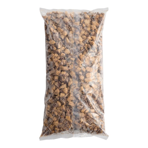 A large clear plastic bag filled with chopped REESE'S Peanut Butter Cup pieces.