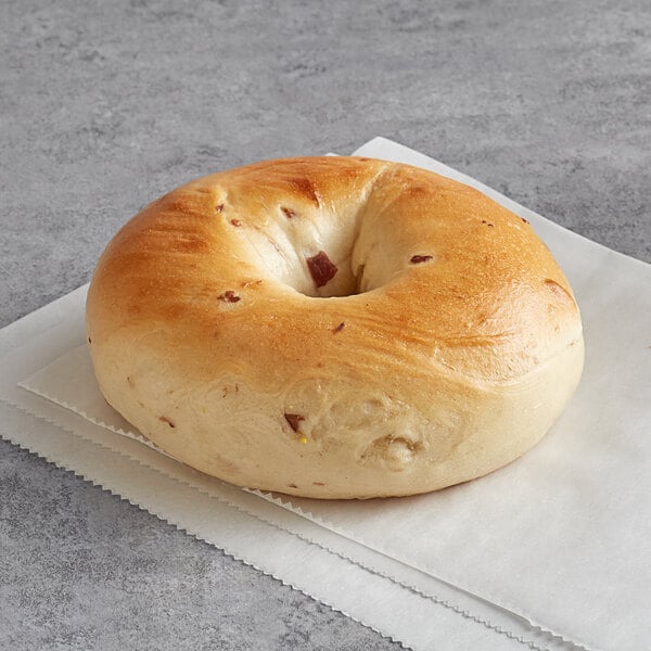 An Original Bagel with cranberries on a napkin.