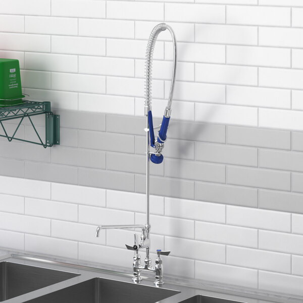 A Waterloo deck-mounted pre-rinse faucet with add-on faucet on a kitchen counter.