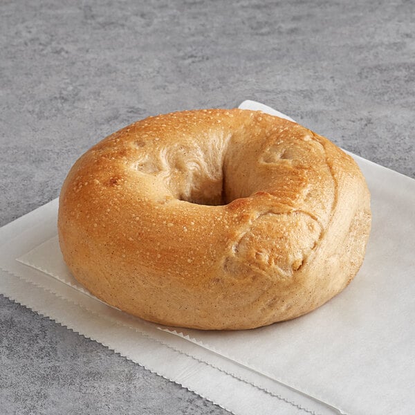 An Original Bagel frozen apple cinnamon bagel on a napkin.