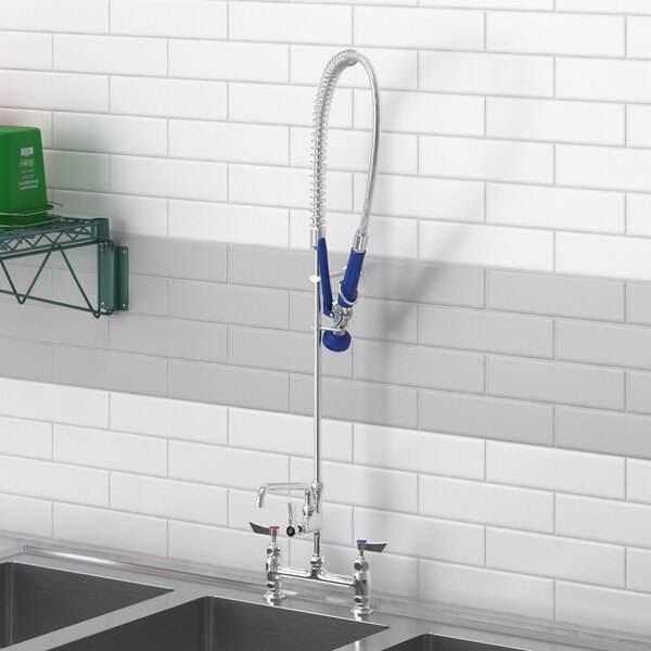 A Waterloo pre-rinse faucet and add-on faucet on a kitchen counter above a sink.