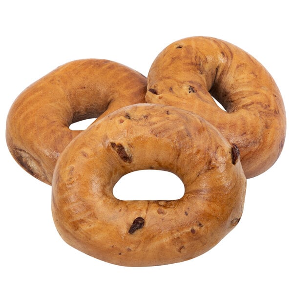 A close-up of a Original Bagel cinnamon raisin bagel with raisins on top.