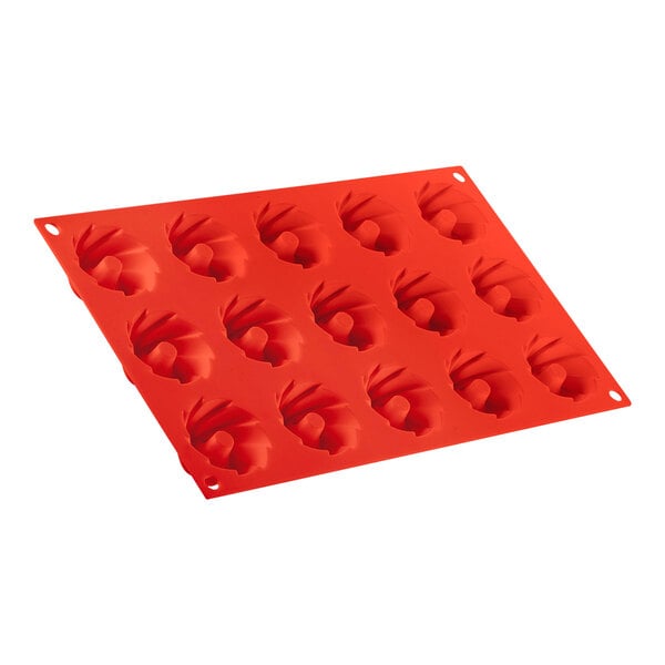 A red Silikomart silicone baking mold with 15 swirl cavities.