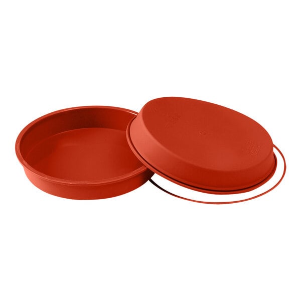 A red round silicone baking mold with a rubber ring lid.