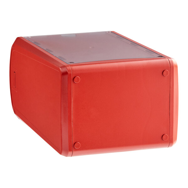 A red Tork countertop napkin dispenser with a clear lid.