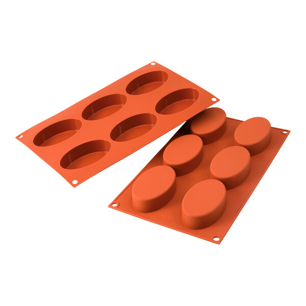 An orange Silikomart silicone baking mold with 6 oval cavities.