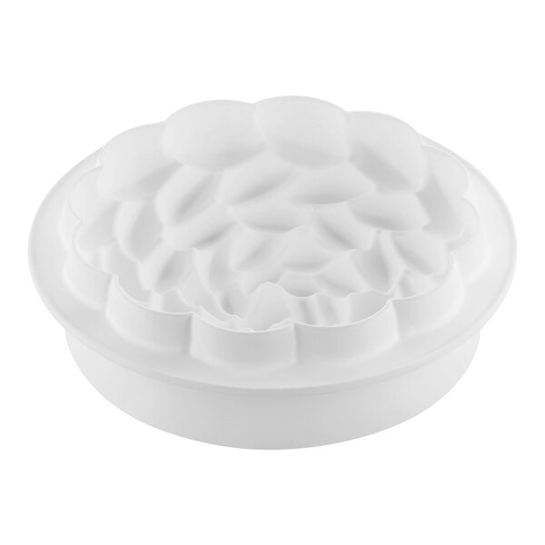 Two white Silikomart flower-shaped silicone baking molds.