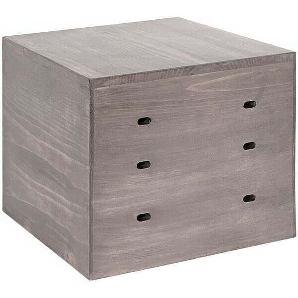 A wooden gray square display riser cube with holes.