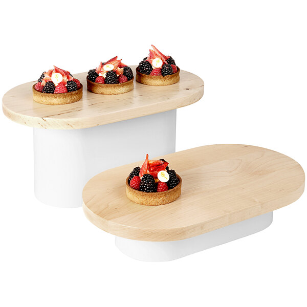 A group of desserts on Cal-Mil maple display risers with fruit and tarts.