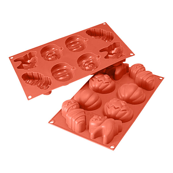 A red Silikomart silicone baking mold with Halloween shapes including a pumpkin.