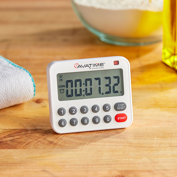 A white AvaTime digital kitchen timer on a wooden surface.